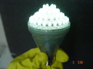 Photo of man holding a 120VAC L.E.D light bulb