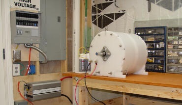 Photo of our Fuel-less Engine SP500 Generator charging a 12 volt DC battery bank with a 5kw inverter connected